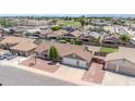 Overhead shot of a well-maintained home with a spacious three-car garage in a quiet neighborhood at 10943 W Alice Ave, Peoria, AZ 85345