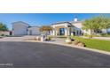 Charming stucco home with manicured lawn and striking desert landscaping, highlighting its curb appeal at 11250 W Prospector Dr, Queen Creek, AZ 85144