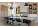 Bright, expansive kitchen with a large island, custom cabinetry, and pendant lighting creating an inviting space at 11250 W Prospector Dr, Queen Creek, AZ 85144