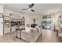 Bright living room boasts tile floors, entertainment center, piano, and sliding doors to a landscaped backyard at 12062 W Duane Ln, Peoria, AZ 85383