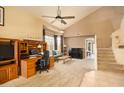 Living room with high vaulted ceilings, carpet, a ceiling fan, and a staircase to the second floor at 12933 W Monterey Way, Avondale, AZ 85392