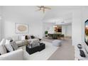 Open-concept living area with a dining space, neutral decor, and a ceiling fan enhancing the interior at 14000 N 94Th St # 3198, Scottsdale, AZ 85260