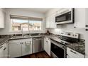 Modern kitchen with stainless steel appliances, granite countertops, and ample cabinet space at 14235 N 26Th Ln, Phoenix, AZ 85023