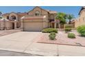 Charming two-story home featuring a two-car garage, drought-resistant landscaping, and a well-manicured front yard at 1606 N Apache Dr, Chandler, AZ 85244