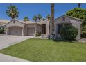 Single-story home with a three-car garage, manicured lawn, desert landscaping, and an inviting entrance at 1826 W Oriole Way, Chandler, AZ 85286