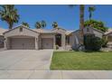 Inviting single-story home featuring a three-car garage, desert landscaping, and charming curb appeal at 1826 W Oriole Way, Chandler, AZ 85286