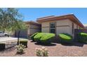 Single-story home with desert landscaping and trimmed bushes at 18617 W Williams St, Goodyear, AZ 85338