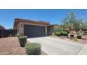 Single-story home with desert landscaping and a driveway at 18617 W Williams St, Goodyear, AZ 85338
