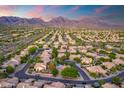 Expansive aerial view showcasing a desert community nestled against a picturesque mountain range at sunset at 19275 N 88Th Way, Scottsdale, AZ 85255