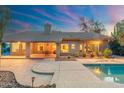 A backyard with an outdoor seating area, pool, covered patio, and well-maintained landscaping at 19275 N 88Th Way, Scottsdale, AZ 85255