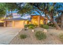 Charming single-story home with a three-car garage, manicured desert landscaping, and a grand entrance at 19275 N 88Th Way, Scottsdale, AZ 85255