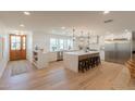 Spacious kitchen with a large island, stainless steel appliances, and modern lighting at 3651 N 49Th Pl, Phoenix, AZ 85018