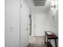 Bright hallway featuring clean white walls, modern flooring, and convenient closet space at 4150 E Cactus Rd # 205, Phoenix, AZ 85032