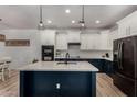 Bright kitchen featuring a center island with marble countertops, stainless steel appliances, and modern pendant lighting at 465 E Frances Ln, Gilbert, AZ 85295