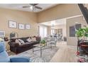 Open living room features vaulted ceilings, modern fan, and is adjacent to the dining area at 4814 W Rose Ln, Glendale, AZ 85301