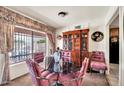 Formal dining room featuring a glass table, upholstered chairs, and a large hutch at 5140 N 69Th Ave, Glendale, AZ 85303