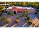 An aerial view of home featuring desert landscaping, brick walkways, tile roof, and two car garage at 6043 E Hearn Rd, Scottsdale, AZ 85254