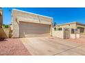 Exterior shot showing the spacious two-car garage and driveway of the property at 619 E Jensen St # 14, Mesa, AZ 85203