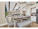 Comfortable dining area offers a view of the living room with beamed ceilings, and natural light at 6352 W Hackamore Dr, Phoenix, AZ 85083