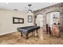 Large bonus room with stone archways and a pool table that makes for a great entertaining space at 6352 W Hackamore Dr, Phoenix, AZ 85083