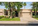 Inviting single-story home with a lush front lawn and convenient two-car garage at 6611 N 79Th Pl, Scottsdale, AZ 85250