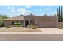Charming single-story home featuring a two-car garage, gravel landscaping, and stylish architectural details at 6717 E Aire Libre Ln, Scottsdale, AZ 85254