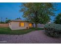 Quaint home with a well-kept lawn and mature tree providing shade and character to the property at 7035 N 11Th Pl, Phoenix, AZ 85020