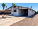 Quaint home with a covered carport, rock landscaping, and a well-maintained front at 7343 E Juanita Ave, Mesa, AZ 85209