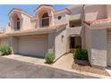 Charming home exterior with a two-car garage, tiled roof, desert landscaping, and covered front porch at 7716 S Rita Ln, Tempe, AZ 85284
