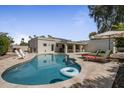 Backyard with a private pool, lounge chairs, and covered patio area; perfect for entertaining at 8343 E Quarterhorse Trl, Scottsdale, AZ 85258