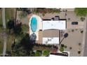 An aerial view of the property, featuring a pool, landscaping, and ample parking at 10232 N 86Th St, Scottsdale, AZ 85258