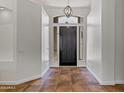 Welcoming foyer features tiled floors and a decorative light fixture at 10310 N 135Th Way, Scottsdale, AZ 85259