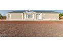 Charming single-story home featuring gravel landscaping, a welcoming covered porch, and curb appeal at 10618 W Prairie Ln, Casa Grande, AZ 85193
