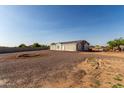 Expansive lot showcases a cozy single-story home and gravel landscaping, offering a tranquil retreat at 10618 W Prairie Ln, Casa Grande, AZ 85193