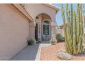 Inviting front porch featuring a cozy seating area surrounded by desert landscaping at 12042 S 44Th St, Phoenix, AZ 85044