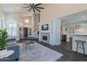 Open-concept living room featuring a fireplace, decorative rug, and seamless flow to the kitchen at 12042 S 44Th St, Phoenix, AZ 85044