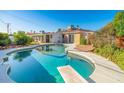 Backyard pool offers a refreshing escape with a diving board and surrounding patio space for entertaining at 12431 N 30Th Ave, Phoenix, AZ 85029