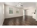 Bright living room featuring hardwood floors, large windows, and a modern ceiling fan at 1255 S Rialto -- # 115, Mesa, AZ 85209