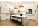 Bright, open kitchen featuring a large island, modern lighting, and stainless steel appliances at 12776 N 78Th St, Scottsdale, AZ 85260