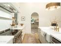 Gourmet kitchen featuring updated appliances, a farmhouse sink, and marble countertops at 12776 N 78Th St, Scottsdale, AZ 85260