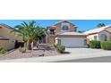 Charming two-story home with desert landscaping, mature palm trees, and a tile roof at 1332 E Charleston Ave, Phoenix, AZ 85022