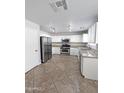 Bright kitchen featuring stainless steel appliances and white cabinets at 1332 E Charleston Ave, Phoenix, AZ 85022