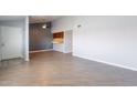 Open-concept living area featuring new wood floors, ceiling fan and a view to kitchen at 1402 E Guadalupe Rd # 207, Tempe, AZ 85283