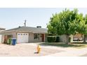 Well-maintained single-story home with brick accents, a garage, and a front lawn at 1412 W 7Th Pl, Tempe, AZ 85281