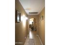 Inviting hallway featuring neutral walls and tile flooring at 16011 N 35Th Dr, Phoenix, AZ 85053