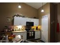 Well-equipped kitchen with white cabinets, a pantry, and modern appliances at 16011 N 35Th Dr, Phoenix, AZ 85053