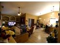 Cozy living room featuring tile floors, a ceiling fan, and a combined dining area at 16011 N 35Th Dr, Phoenix, AZ 85053