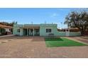 Quaint home featuring desert landscaping and a cozy bench at 1613 W Flower N Cir, Phoenix, AZ 85015
