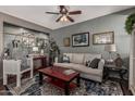 Cozy living room with stylish decor, ceiling fan, and decorative shelving at 1849 S Balboa Dr, Gilbert, AZ 85295