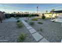 Expansive backyard featuring desert landscaping, a gravel area, and a dedicated fire pit at 1930 W Missouri Ave, Phoenix, AZ 85015